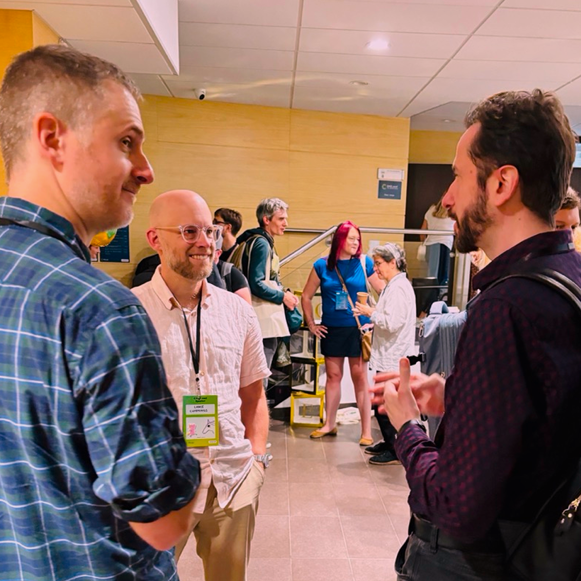 A group of people at CAKE conf chatting during a break